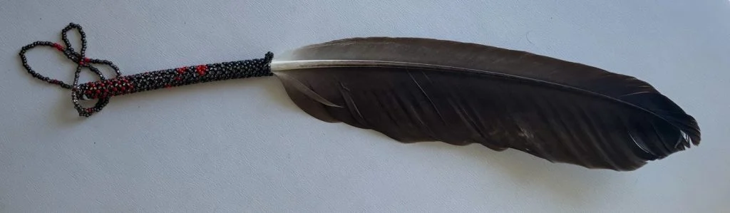 Photo of the Eagle Feather gifted to Paul Ygartua by Hilistis ‘Pauline’ Waterfall, Duka’aisla William Housty, the Hereditary Heiltsuk Chiefs and the Heiltsuk Nation